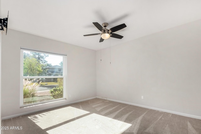 carpeted empty room featuring ceiling fan