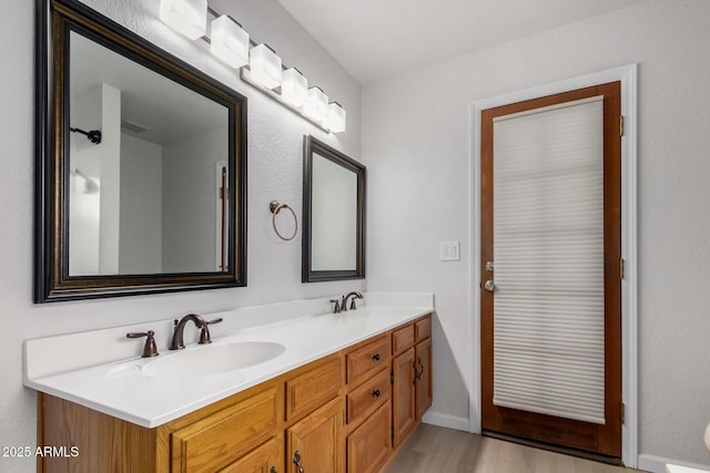 bathroom featuring vanity and hardwood / wood-style flooring