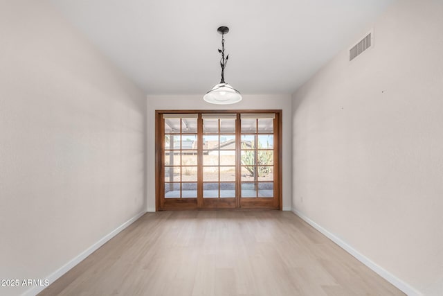 empty room with light hardwood / wood-style floors