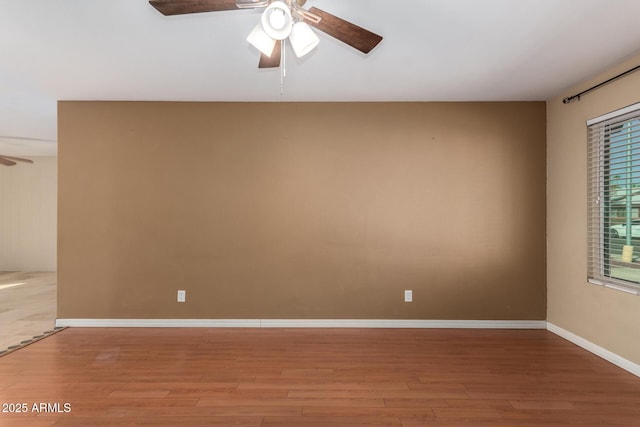 spare room with ceiling fan and hardwood / wood-style floors