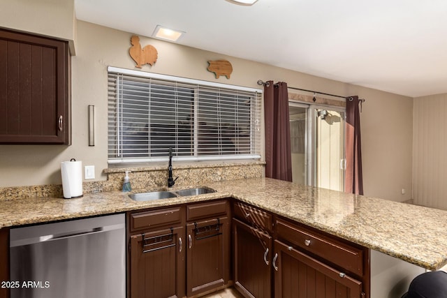 kitchen with dark brown cabinetry, sink, light stone counters, dishwasher, and kitchen peninsula