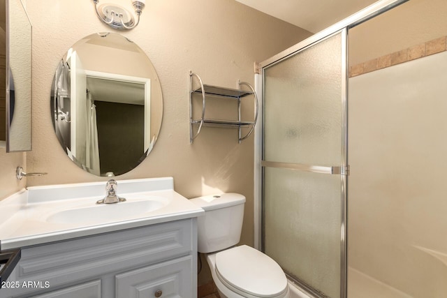 bathroom with vanity, toilet, and an enclosed shower