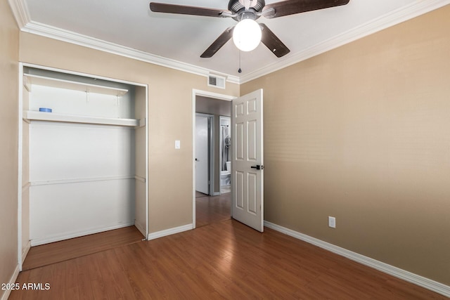 unfurnished bedroom featuring ceiling fan, ornamental molding, hardwood / wood-style floors, and a closet