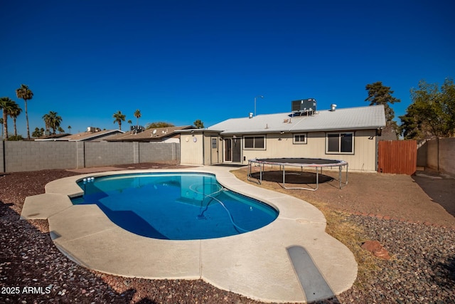 view of swimming pool featuring a trampoline and cooling unit