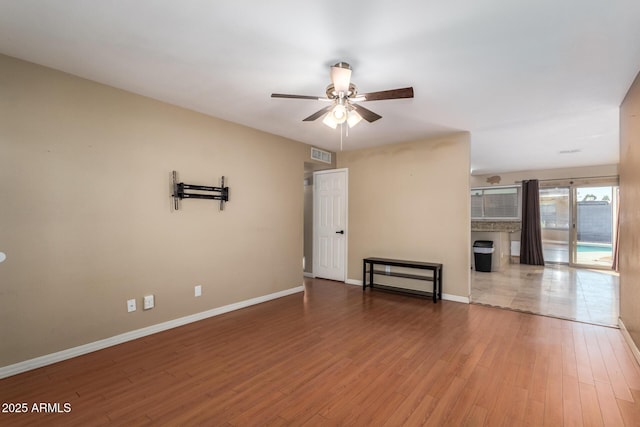 unfurnished living room with hardwood / wood-style flooring and ceiling fan