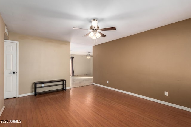 spare room featuring wood-type flooring and ceiling fan