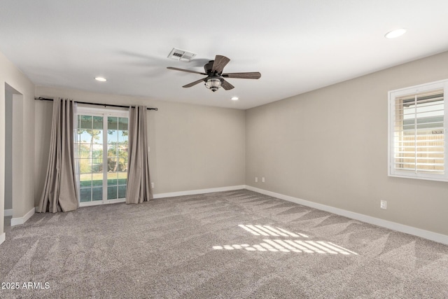 carpeted spare room with ceiling fan