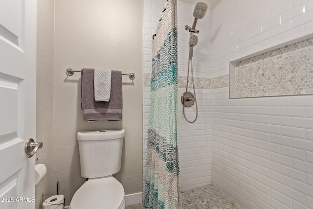 bathroom with a shower with curtain and toilet