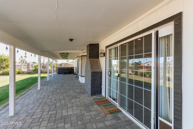 view of patio / terrace with a hot tub