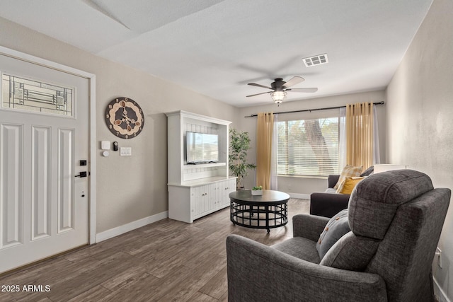 sitting room with ceiling fan and wood-type flooring