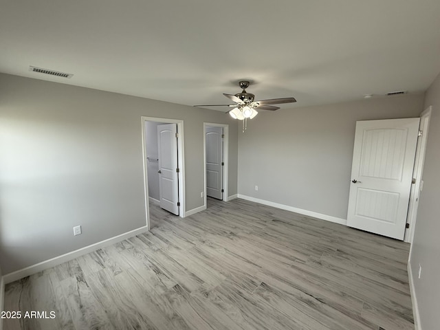 unfurnished bedroom featuring light hardwood / wood-style flooring and ceiling fan