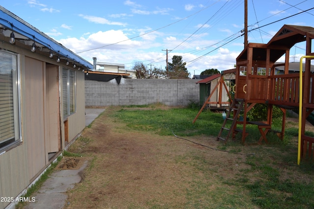 view of yard with a playground and fence