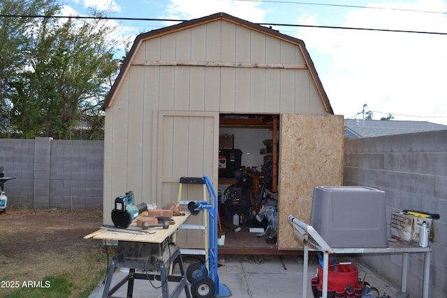 view of shed featuring fence