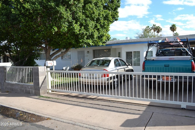 view of front of home featuring fence