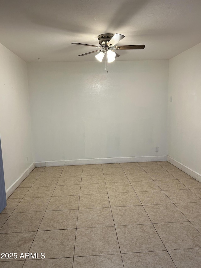 unfurnished room featuring light tile patterned floors, baseboards, and a ceiling fan