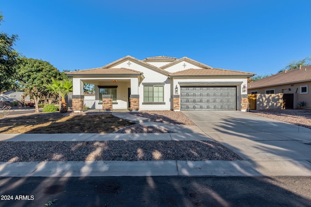 view of front of property featuring a porch and a garage