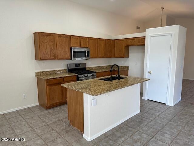 21192 N 80th Ln, Peoria, AZ 85382 - kitchen featuring appliances with stainless steel finishes, a sink, vaulted ceiling, brown cabinetry, and stone counters