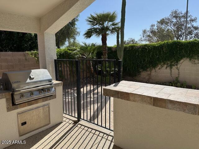 21192 N 80th Ln, Peoria, AZ 85382 - view of patio / terrace with area for grilling, exterior kitchen, and fence