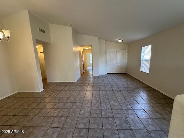 21192 N 80th Ln, Peoria, AZ 85382 - unfurnished bedroom with vaulted ceiling, tile patterned floors, baseboards, and a closet