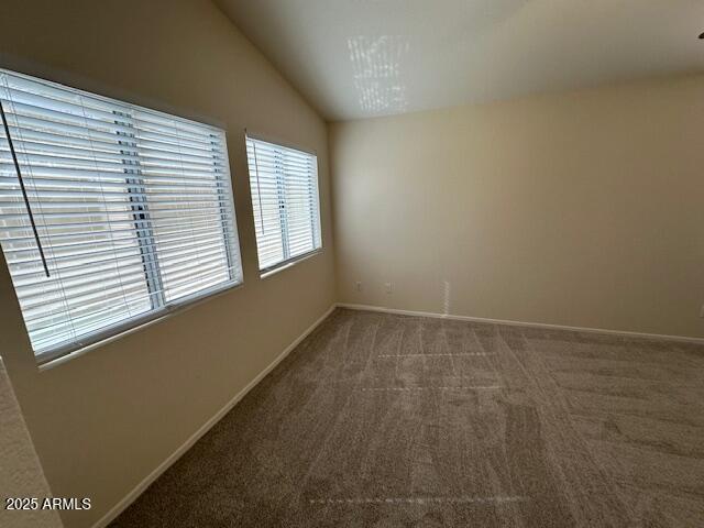 21192 N 80th Ln, Peoria, AZ 85382 - spare room featuring carpet, vaulted ceiling, and baseboards