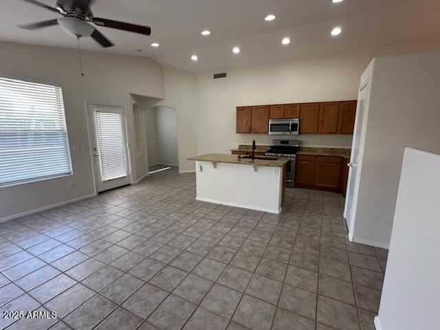 21192 N 80th Ln, Peoria, AZ 85382 - kitchen featuring appliances with stainless steel finishes, open floor plan, vaulted ceiling, ceiling fan, and recessed lighting