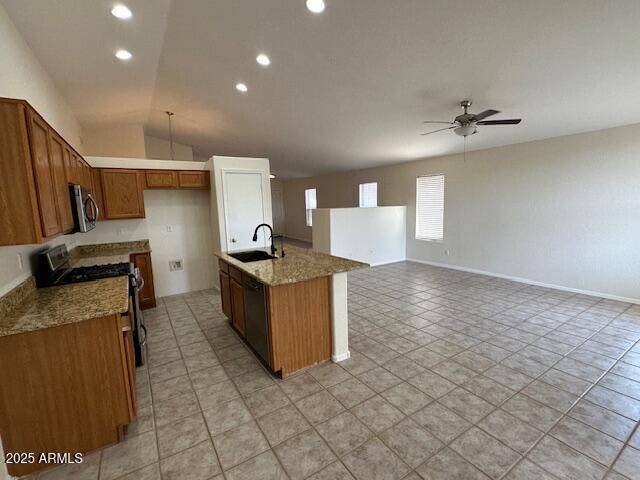 21192 N 80th Ln, Peoria, AZ 85382 - kitchen with stainless steel appliances, a sink, a ceiling fan, brown cabinetry, and open floor plan