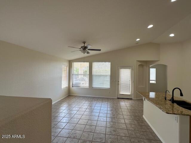 21192 N 80th Ln, Peoria, AZ 85382 - unfurnished room featuring plenty of natural light, a sink, a ceiling fan, arched walkways, and lofted ceiling