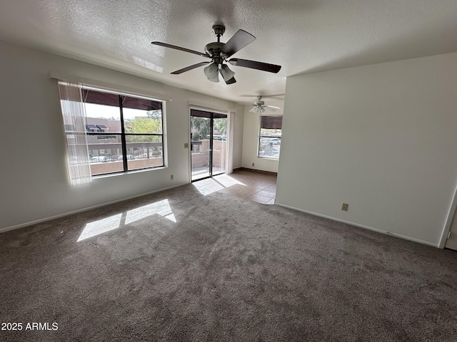 unfurnished room with baseboards, carpet floors, and a textured ceiling