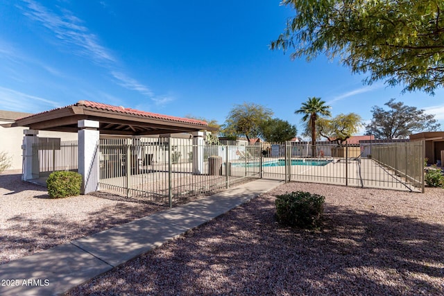 exterior space featuring a gazebo, a swimming pool, fence, and a patio