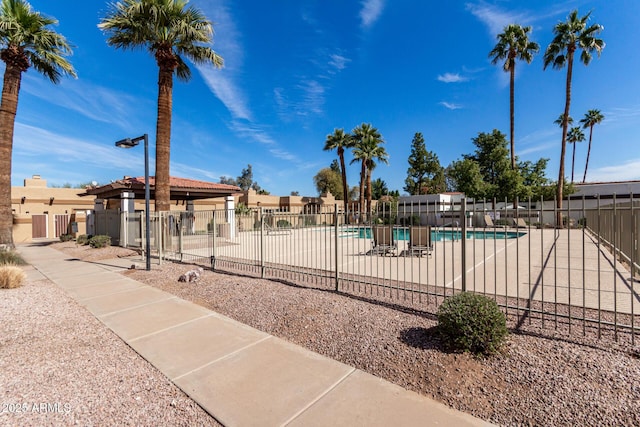 pool featuring a patio area and fence