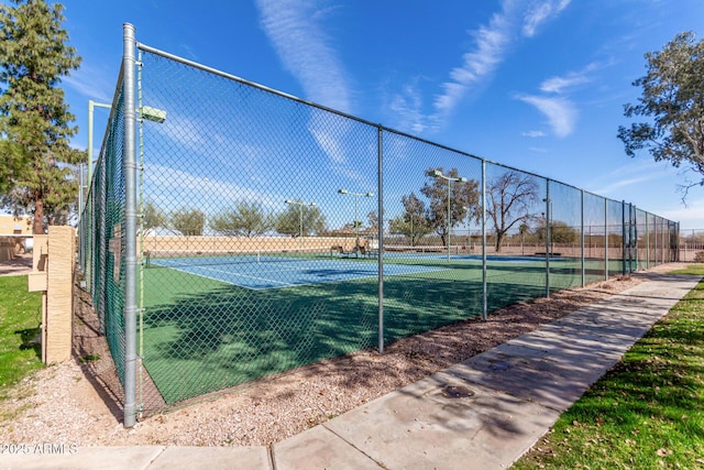 view of tennis court with fence