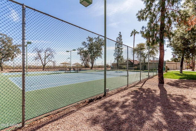 view of sport court featuring fence