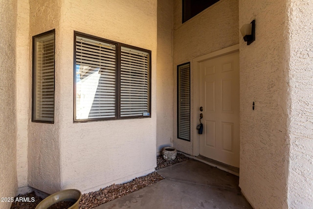 view of exterior entry with stucco siding