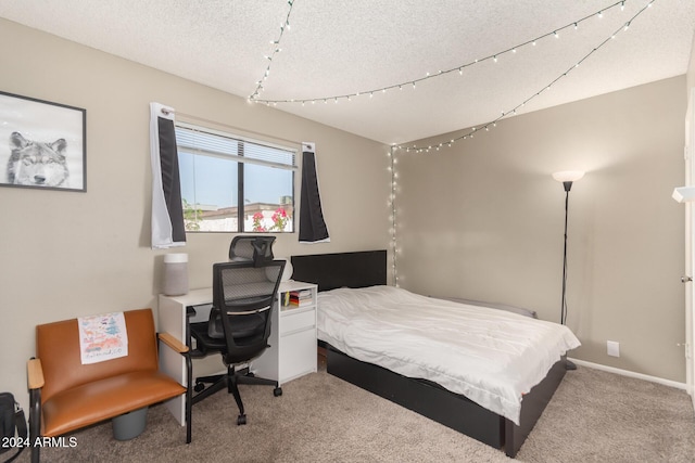 bedroom with a textured ceiling and carpet floors