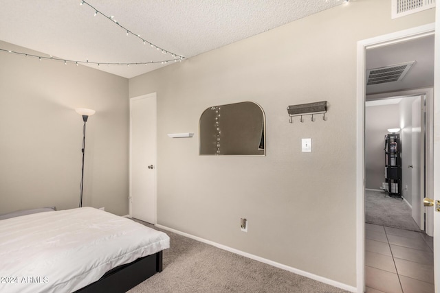 bedroom featuring carpet flooring and a textured ceiling