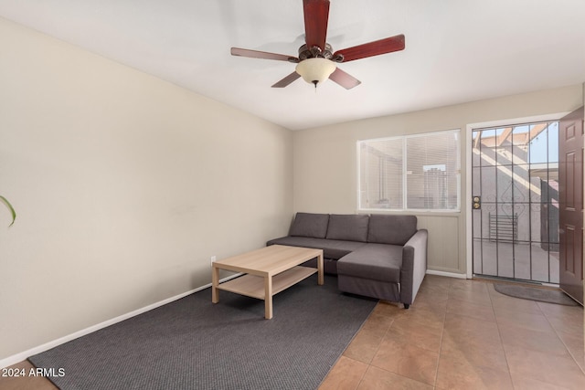 living room with ceiling fan and light tile patterned flooring