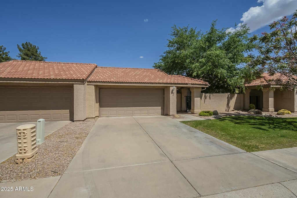 945 N Pasadena Unit 84, Mesa, AZ 85201 - ranch-style home with stucco siding, concrete driveway, a garage, and a tile roof