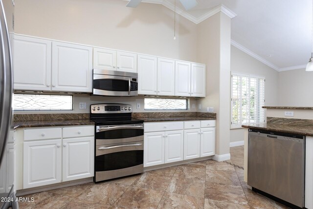 kitchen featuring ornamental molding, high vaulted ceiling, stainless steel appliances, and white cabinets