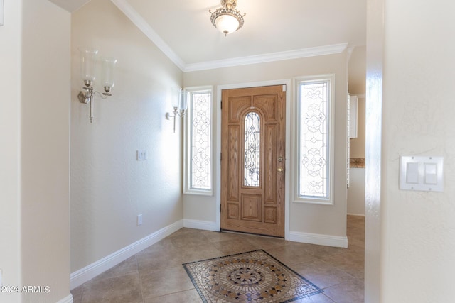 foyer entrance with baseboards, ornamental molding, a healthy amount of sunlight, and light tile patterned flooring