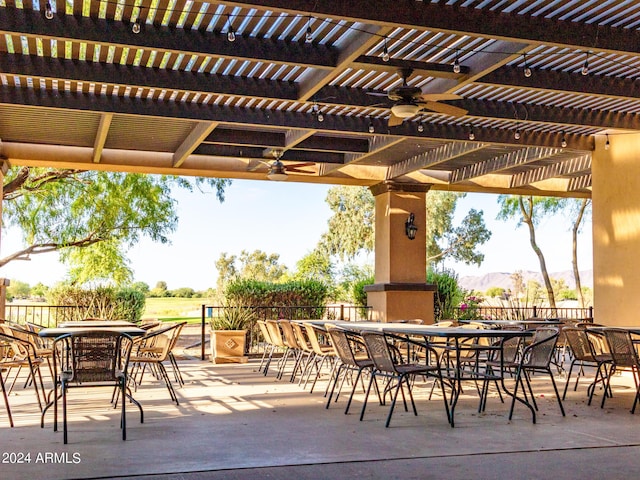 view of patio with a pergola, outdoor dining area, fence, and a ceiling fan
