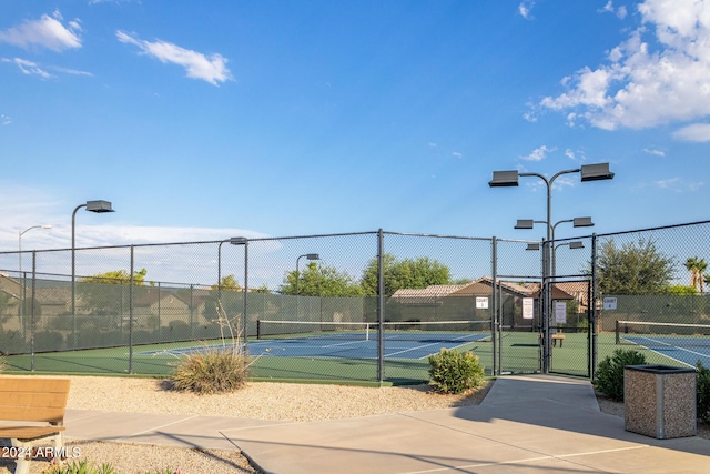 view of sport court featuring a gate and fence