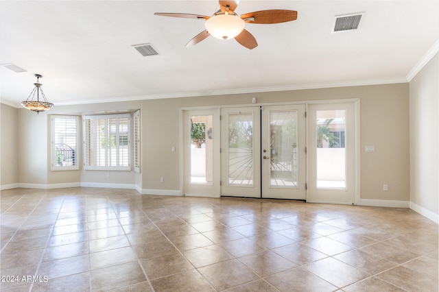 spare room with crown molding, light tile patterned floors, ceiling fan, and french doors