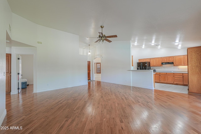 238 W Myrna Ln, Tempe, AZ 85284 - unfurnished living room featuring high vaulted ceiling, a ceiling fan, and light wood-style floors