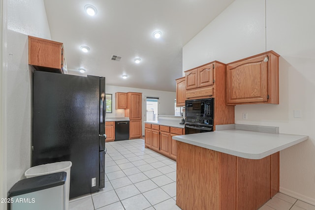 238 W Myrna Ln, Tempe, AZ 85284 - kitchen featuring black appliances, a peninsula, vaulted ceiling, light tile patterned flooring, and light countertops