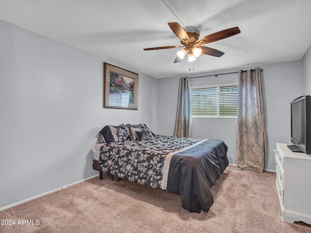 bedroom featuring baseboards, ceiling fan, carpet flooring, and a textured ceiling