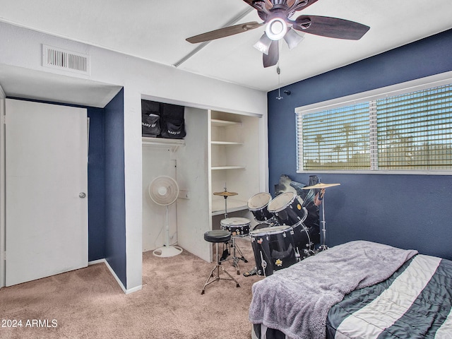 carpeted bedroom featuring visible vents, a ceiling fan, and a closet