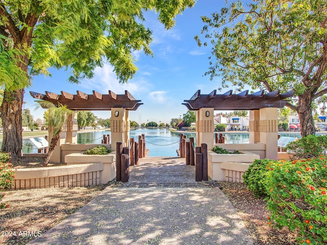 surrounding community with a water view and a dock