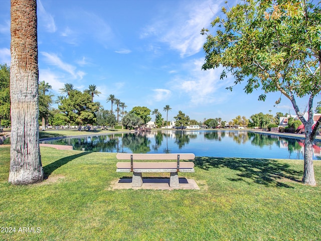 view of community featuring a yard and a water view