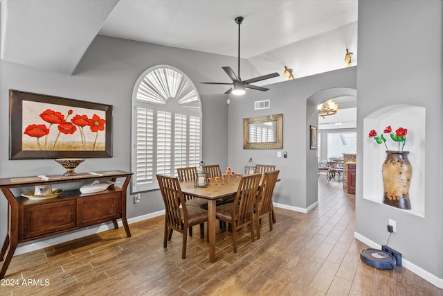 dining room featuring lofted ceiling, hardwood / wood-style floors, and ceiling fan