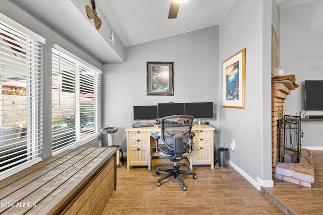 office space with ceiling fan, lofted ceiling, and light hardwood / wood-style floors